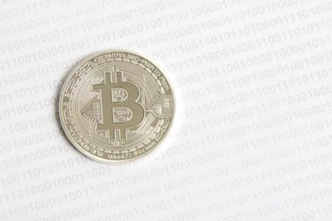 Bitcoin on the background of binary code Stock Photos