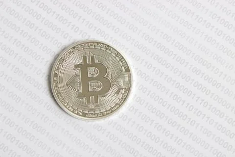 Bitcoin on the background of binary code Stock Photos