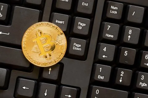 Bitcoin on black computer keyboard Stock Photos