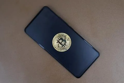 Bitcoin on a black smartphone screen Stock Photos
