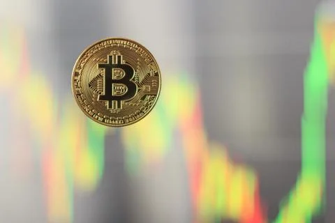 Bitcoin with a blurred graph in the background, the concept of rising and fal Foto stock