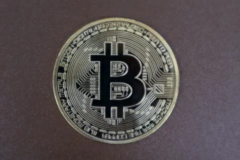 Bitcoin on a brown background Stock Photos