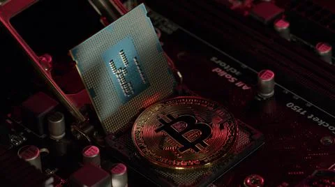 Bitcoin BTC and CPU central processor on digital technology pc motherboard Stock Photos