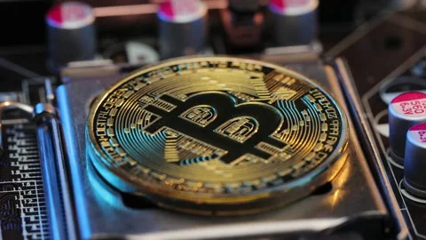 Bitcoin BTC and CPU processor on the motherboard. Gold bitcoin cryptocurrency Stock Footage 194639896