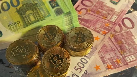Bitcoin BTC bit coin stacks lies on many euros money bills rotating background Stock Footage 266989680