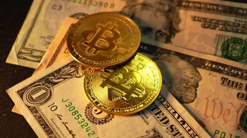 Bitcoin BTC coin with 100 dollars bills. Investments for the investor Stock Footage 327706639