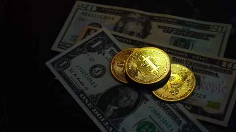 Bitcoin BTC coin with 100 dollars bills. Investments for the investor Stock Footage 327706676