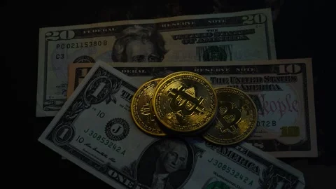 Bitcoin BTC coin with 100 dollars bills. Investments for the investor Stock Footage 327706677