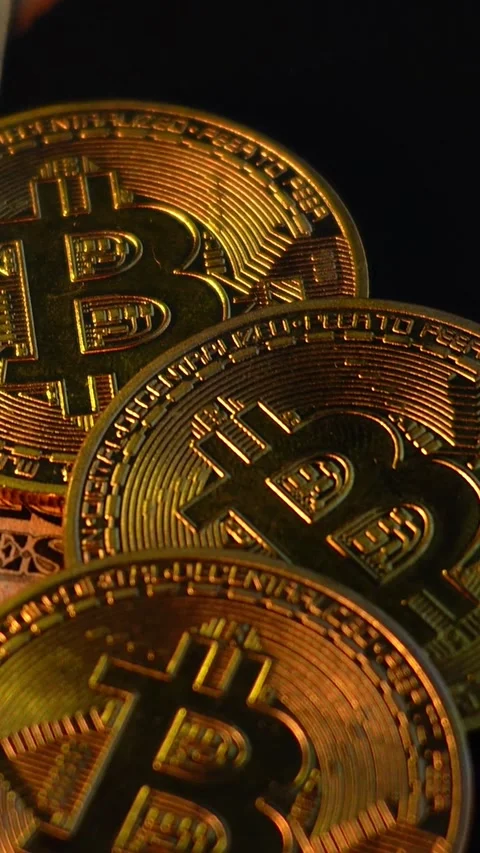 Bitcoin BTC coin with 100 dollars bills. Investments for the investor Stock Footage 327728308