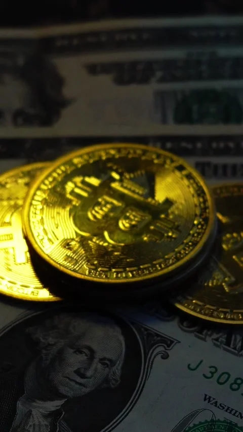 Bitcoin BTC coin with 100 dollars bills. Investments for the investor Stock Footage 327728347