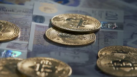 Bitcoin BTC coin rotating on bills of 20 pounds Video stock 258834133