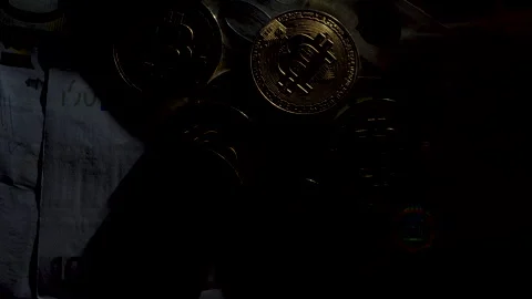Bitcoin BTC coin rotating on bills of 100 and 50 euro Stock Footage 258835988