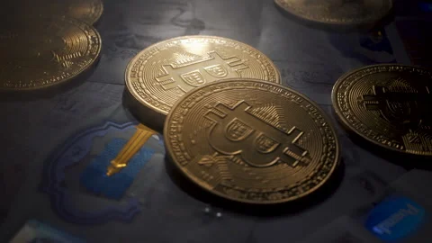 Bitcoin BTC coin rotating on bills of 20 pounds Stock-Footage 258836712