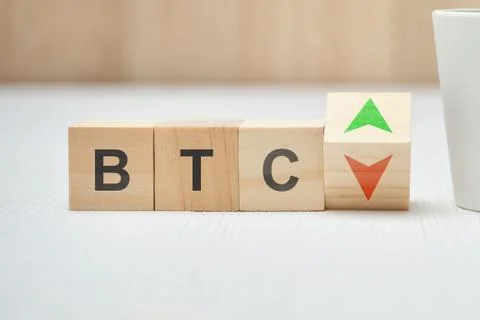 Bitcoin btc cryptocurrency with up and down arrows on wooden blocks. Stock Photos