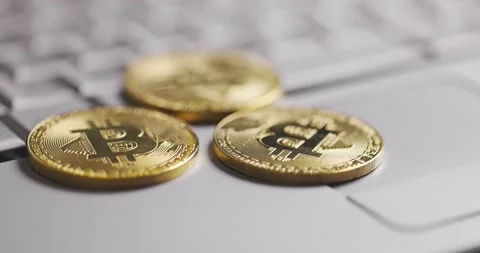 Bitcoin BTC cryptocurrency. Golden coins falling on laptop keyboard. Profit Stock Footage 149077997