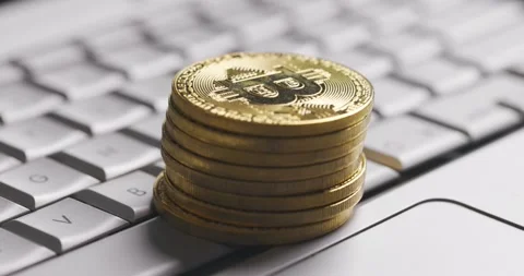 Bitcoin BTC cryptocurrency. Stack of golden coins on laptop keyboard, macro shot Stock Footage 149078042