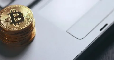Bitcoin BTC cryptocurrency. Stack of golden coins on laptop keyboard, macro shot Stock Footage 149273585