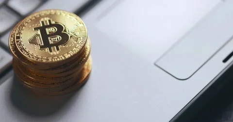 Bitcoin BTC cryptocurrency. Stack of golden coins on laptop keyboard, macro shot Stock Footage 149442754