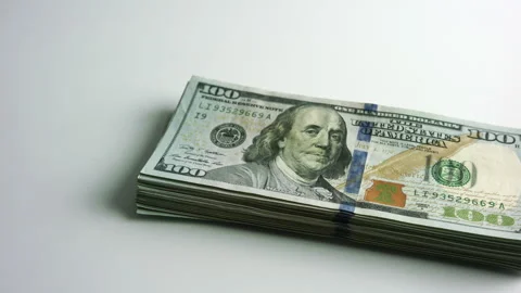 Bitcoin BTC exchanging to wad or stack of 100 hundred dollars bills cash USD Stock Footage 151924264