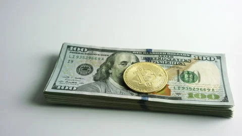 Bitcoin BTC exchanging to wad or stack of 100 hundred dollars bills cash USD Stock Footage 151924446