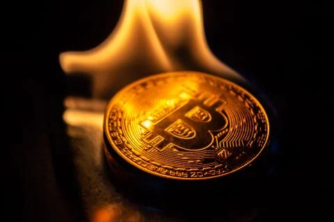 Bitcoin burning in fire on black background Stock Photos