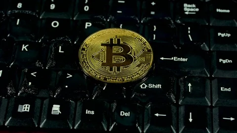 Bitcoin burns on black keyboard Video stock 86789809