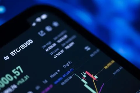 Bitcoin to BUSD trading chart on a smartphone crypto exchange app Stock Photos