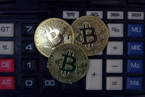 Bitcoin on calculator Stock Photos