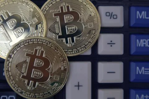 Bitcoin on calculator Stock Photos