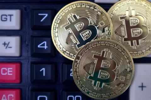 Bitcoin on calculator Stock Photos