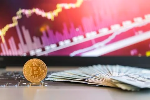 Bitcoin, chart and us dollar. Finance trading. Dollar bills laying on a lapto Stock Photos