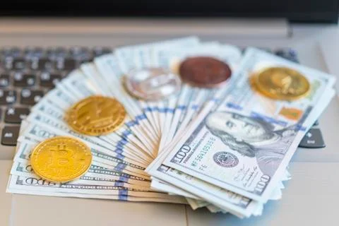 Bitcoin, chart and us dollar. Finance trading. Dollar bills laying on a lapto Stock Photos