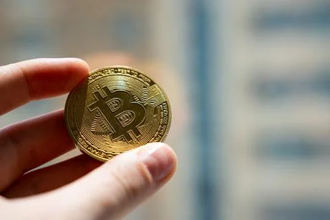 Bitcoin close-up in hand Stock Photos