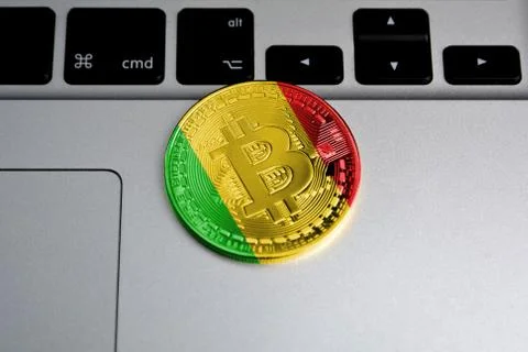 Bitcoin close-up on keyboard background, the flag of Mali is shown on bitcoin Stock Photos
