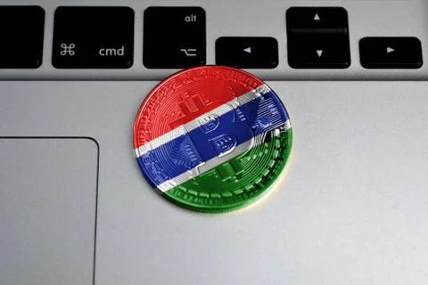 Bitcoin close-up on keyboard background, the flag of Gambia is shown on bitcoin 写真素材