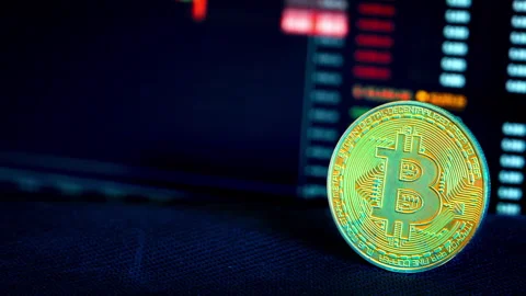 Bitcoin Coin Against the Background of a Cryptocurrency Chart Vídeo Stock 261601712