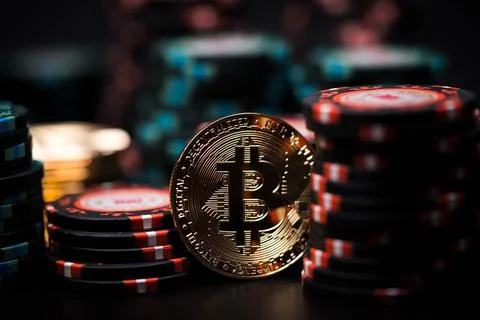 Bitcoin coin on the background of casino playing chips. Stock Photos