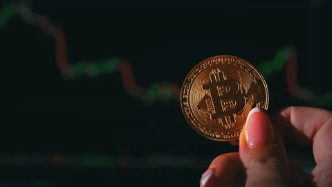Bitcoin Coin on Background of a Cryptocurrency Trading Chart on Computer Screen Stock Footage 211800737