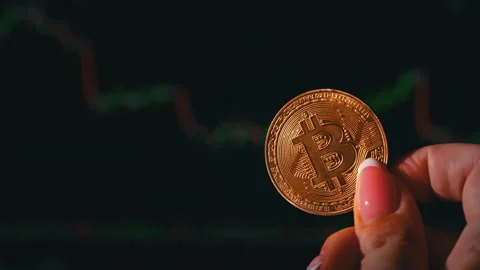 Bitcoin Coin on Background of a Cryptocurrency Trading Chart on Computer Screen Stock Footage 211892288