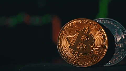 Bitcoin Coin on Background of a Cryptocurrency Trading Chart on Computer Screen Stock Footage 212092030