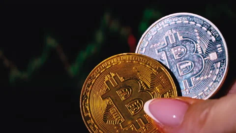 Bitcoin Coin on Background of a Cryptocurrency Trading Chart on Computer Screen 動画素材 212493944