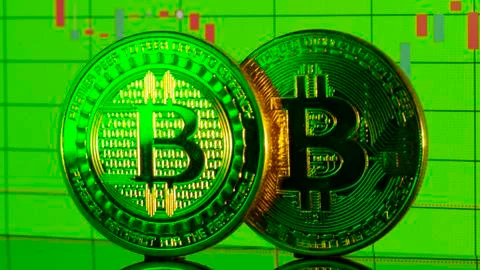 Bitcoin coin on the background graphics close-up Stock Photos