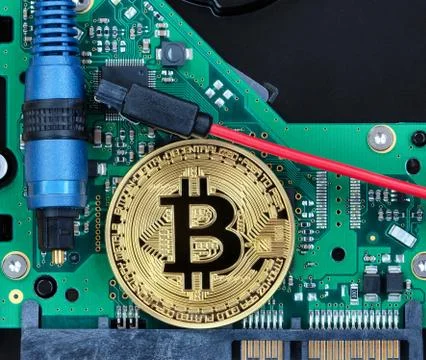 Bitcoin coin on circuit board of computer with fiber optic cables for currenc Stock Photos