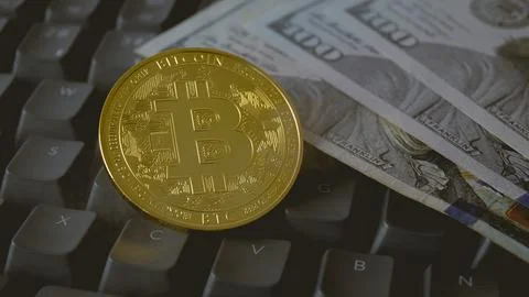 Bitcoin coin close-up on a computer keyboard in smoke. Stock Photos