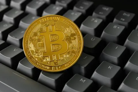 Bitcoin coin close-up on a computer keyboard. Stock Photos