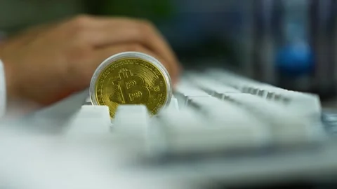 Bitcoin coin on computer keyboard, cryptocurrency finance concept Vídeo Stock 329176965