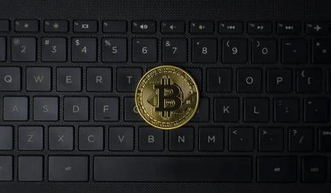 Bitcoin Coin On Computer Keyboard Cryptocurrency Concept Stock Photos