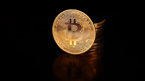 Bitcoin Coin Emerging from Darkness on Black Background Stock Footage 339568906