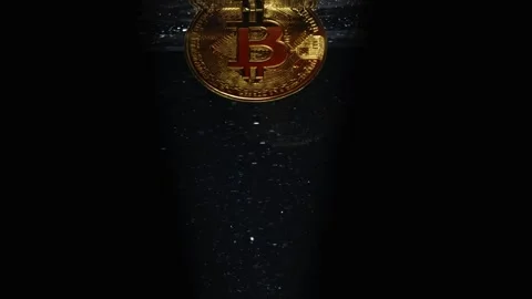 Bitcoin coin falling to the bottom on a dark background. The value of BTC h.. Stock Footage 251335021