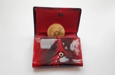 Bitcoin coin in half opened red wallet 写真素材